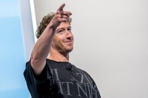 Person pointing and smiling at Meta's LlamaCon event