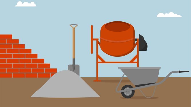 Construction scene showing cement mixer, pile of sand with shovel, wheelbarrow, and partially built brick wall outdoors under a cloudy sky