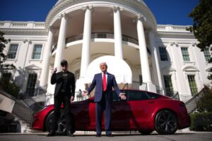 Two individuals standing in front of a red car in front of a white building resembling the White House, symbolizing North America's dominance in AI investment amidst political challenges.